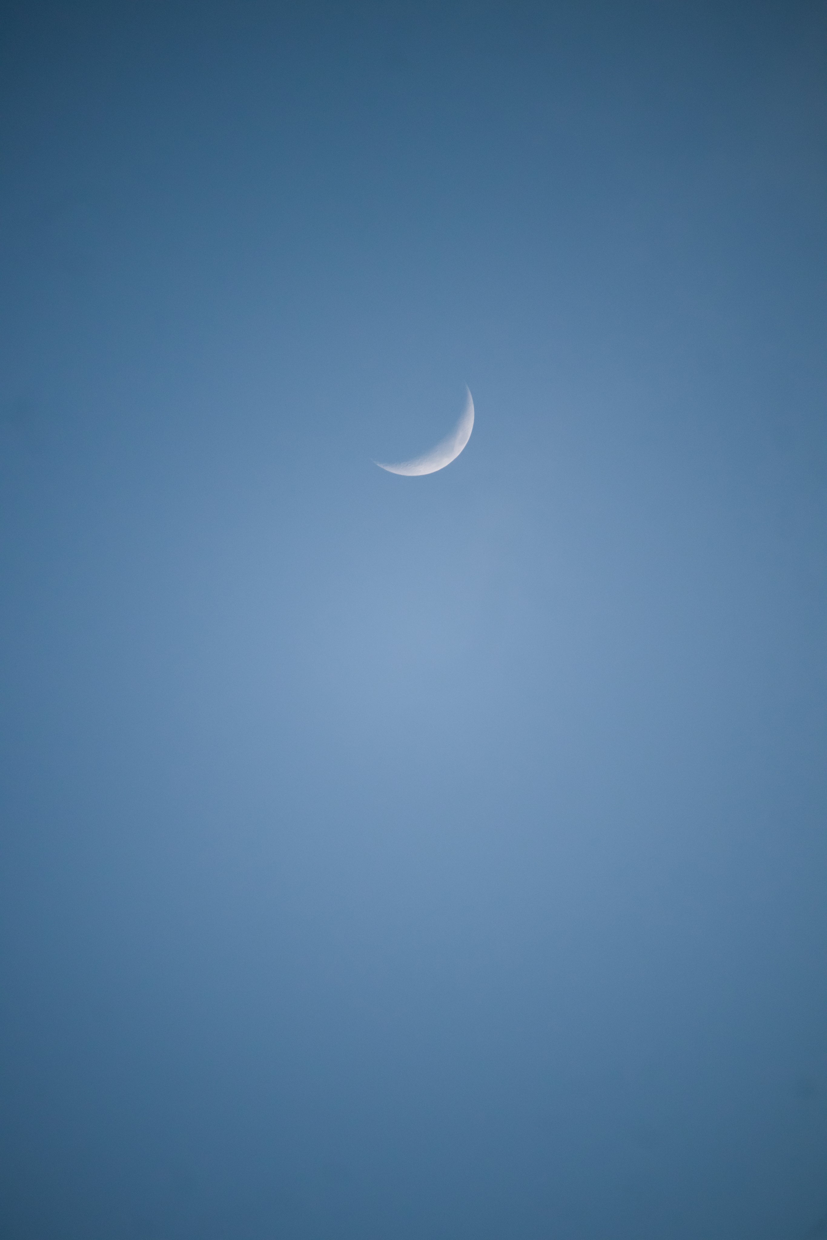 small-sliver-of-the-moon-in-a-blue-sky.jpg